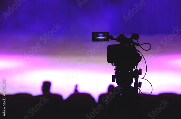 Fototapeta Video recorder silhouette in front of stage before show begins