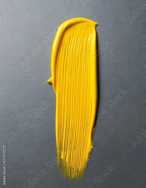 Fototapeta Glossy yellow paint stroke on a grey background , isolated, copy space 