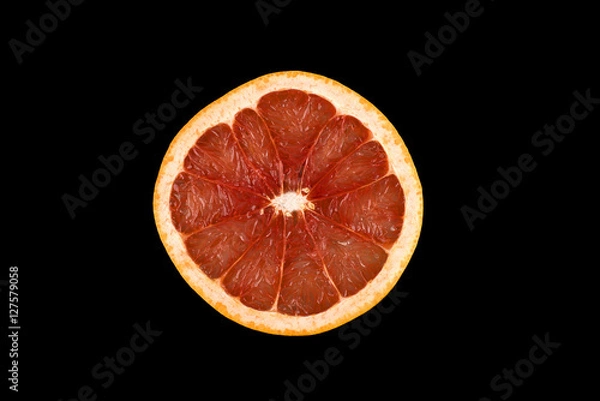 Fototapeta Slice of grapefruit on a black background