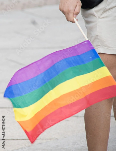 Obraz unrecognizable person holding rainbown flag pride day. summer. stret. Horizontal
