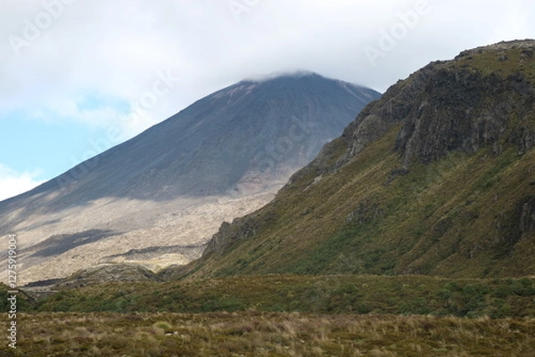 Fototapeta A volcanic mountain peak in New Zealand with barren rocky slopes and a deep blue sky. A breathtaking view of geological wonder and adventure.