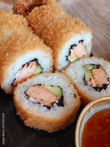 Obraz Enjoy these delicious, crispy sushi rolls filled with salmon and creamy avocado