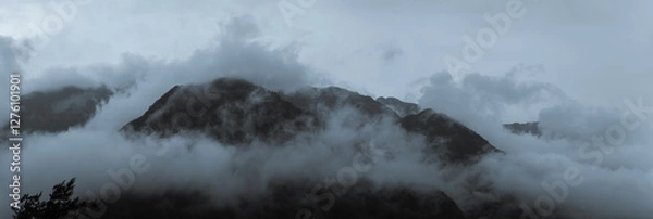Fototapeta Dark Misty Clouds Engulf Towering Mountain Peaks Creating a Dramatic and Mysterious Atmosphere in Taiwan’s Wilderness