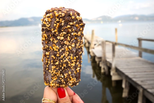 Fototapeta chocolate ice cream / Hand holding bitten ice cream / Ice Cream holded by hand /  hand holding ice cream / ice cream