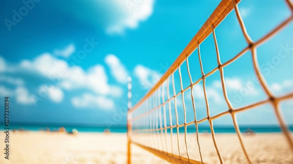 Fototapeta vibrant beach volleyball court with net against stunning blue sky and ocean backdrop, inviting fun and relaxation