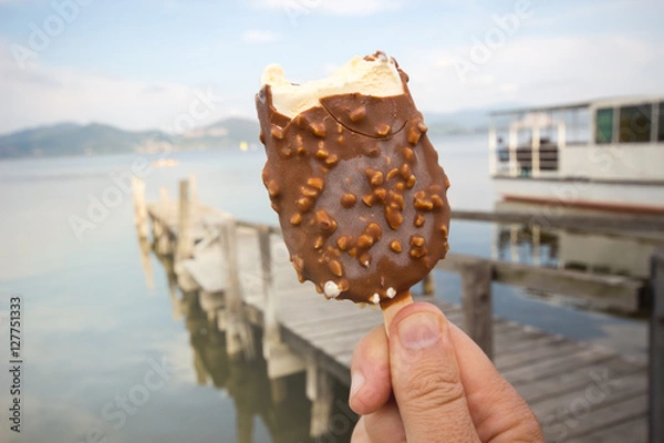 Fototapeta chocolate ice cream / Hand holding bitten ice cream / Ice Cream holded by hand /  hand holding ice cream / ice cream