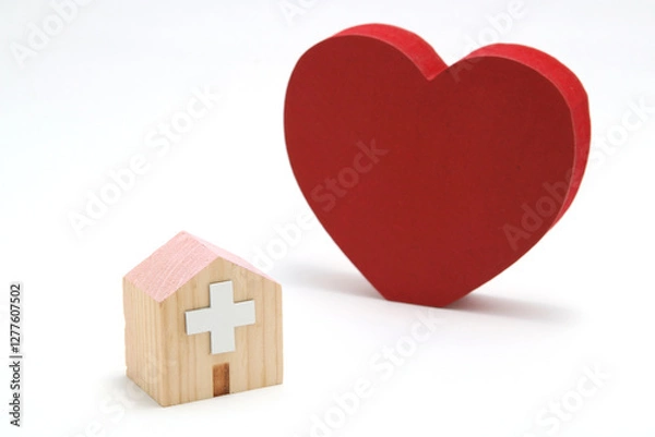 Fototapeta ハートと病院のミニチュア – 医療・福祉・健康のイメージ