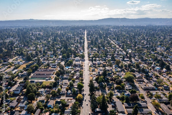 Obraz Aerial drone view of Southeast Portland, Oregon, showcasing residential neighborhoods, tree-lined streets, urban landscape, and distant downtown skyline under a partly cloudy sky