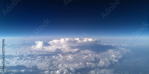 Fototapeta A view of the clouds from an airplane, showinound