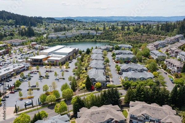 Obraz Aerial drone view of Beaverton, Oregon, featuring Progress Lake Park, residential neighborhoods, shopping centers, and parking lots, with tree-lined streets and a mix of suburban and commercial spaces