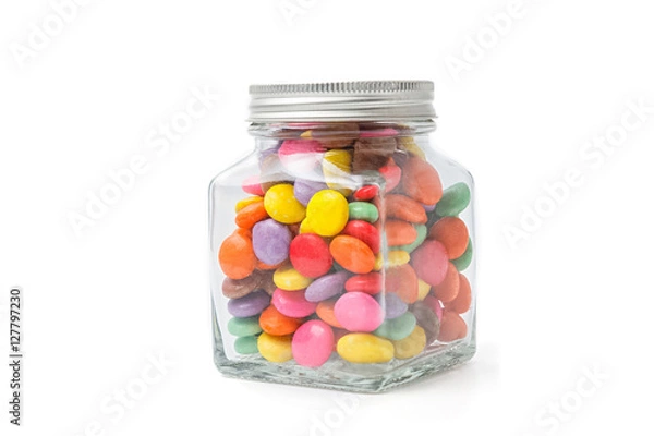Obraz Colorful chocolate candies in glass bottle