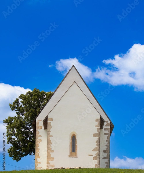 Obraz The Church of St. Andrew in Kamešnica, dating back to the 14th century, has preserved its original Gothic appearance with a steep double-pitched roof.