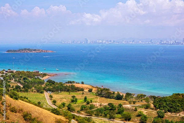Fototapeta Viewpoint photo taken from the viewpoint on Koh Larn, showing the nature on the island and the crystal clear blue sea, with Pattaya City, Chonburi Province, Thailand as the backdrop