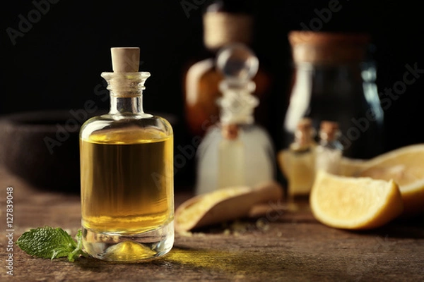 Obraz Beautiful spa composition with lemon essential oil on wooden table, closeup