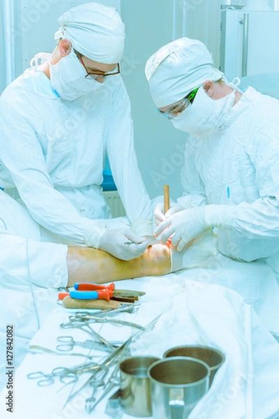 Fototapeta Doctors operate on a patient