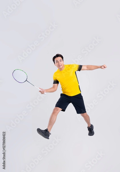 Fototapeta Portrait of Asian man playing badminton on white background.