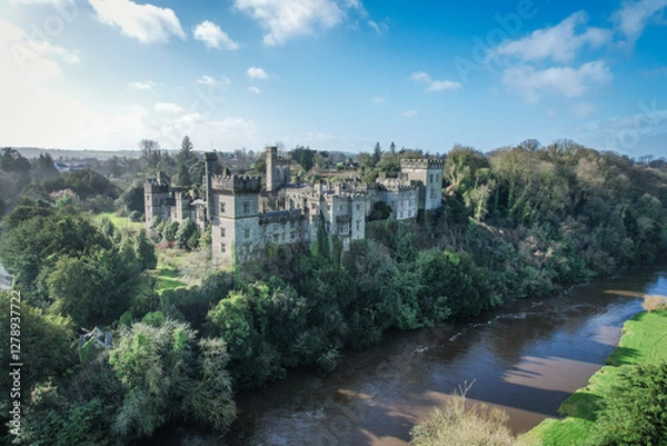Fototapeta Aerial view of Lismore Castle, Ireland, showcasing its stunning Gothic architecture and scenic riverside location