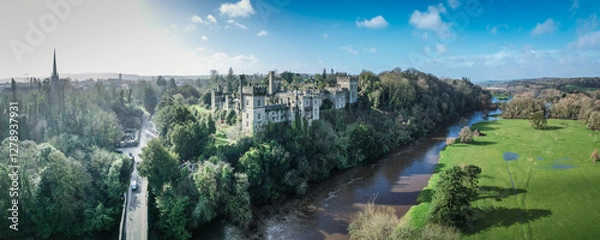 Fototapeta Aerial view of Lismore Castle, Ireland, showcasing its stunning Gothic architecture and scenic riverside location
