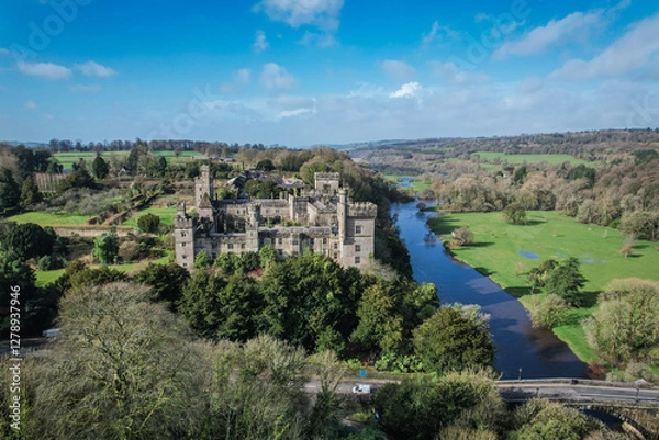 Fototapeta Aerial view of Lismore Castle, Ireland, showcasing its stunning Gothic architecture and scenic riverside location