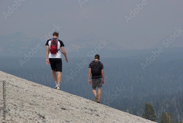 Obraz Men walking into distance on mountain