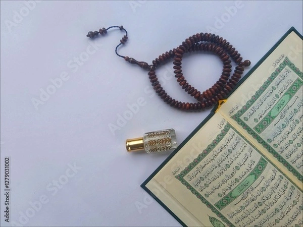 Fototapeta Al Quran, Tasbih and Perfume in the month of Ramadhan in a flat lay portrait