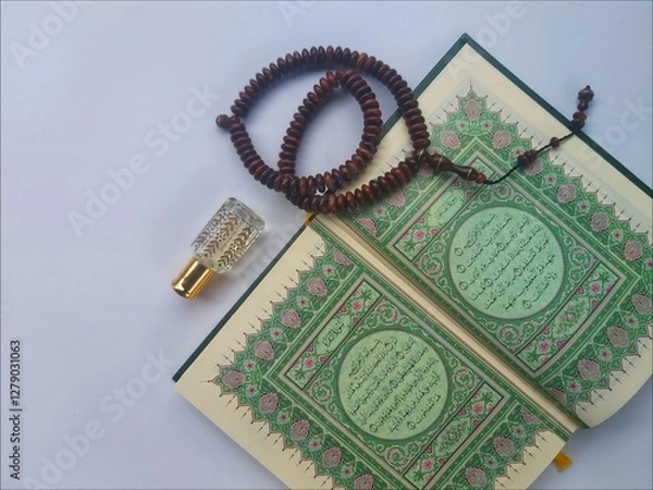 Fototapeta Al Quran, Tasbih and Perfume in the month of Ramadhan in a flat lay portrait
