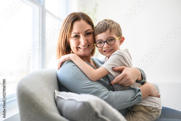 Fototapeta Portrait of boy smiling at camera with her mother at home