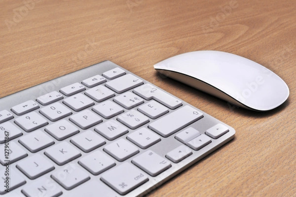 Fototapeta Keyboard and mouse on a wooden background, close-up