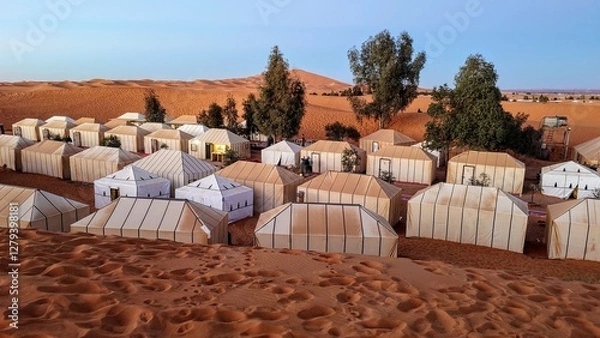 Obraz Desert camp with traditional tents in the sand dunes of Merzouga, Morocco, under a clear blue sky