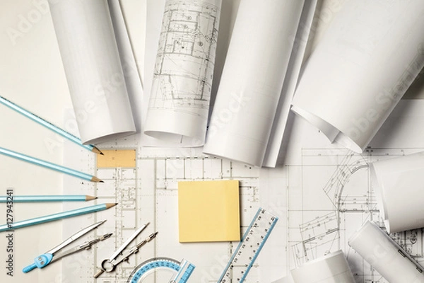 Fototapeta Workplace of architect - rolls and plans.