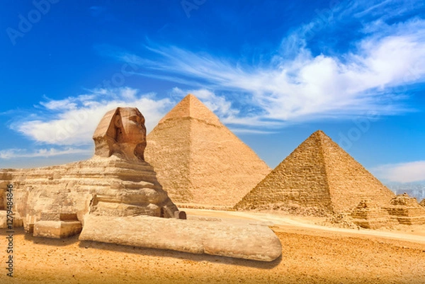 Fototapeta The Great Sphinx and Pyramids in Giza against blue cloudy sky in Giza, Cairo, Egypt