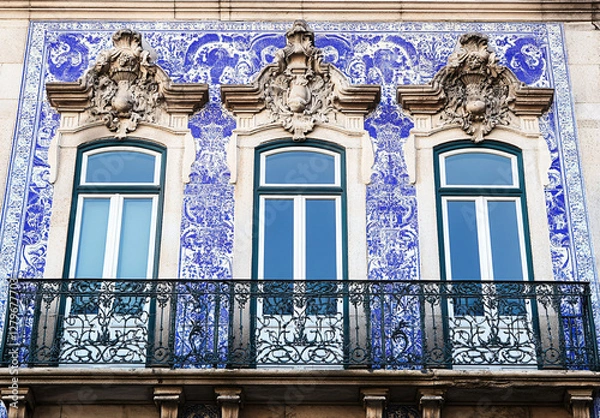 Obraz Traditional Portuguese building facade with azulejo tiles, balcony, and vibrant colors.