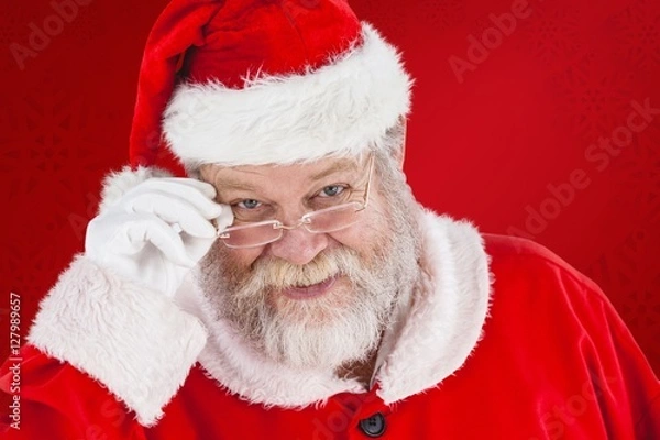 Fototapeta Composite image of santa claus holding spectacles