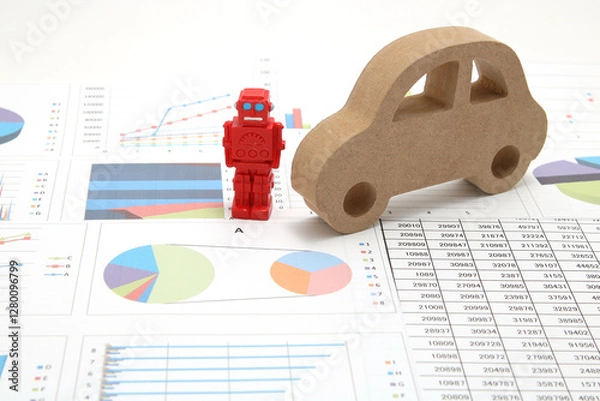 Fototapeta Business concept with miniature robot, car model, and financial graphs