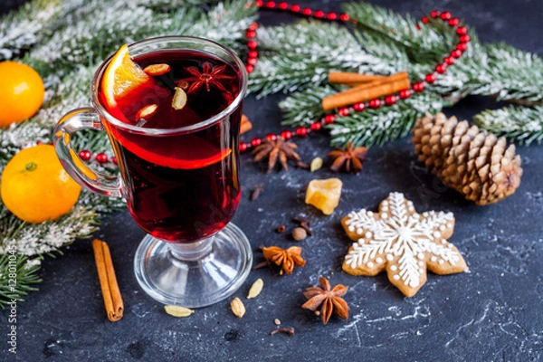 Obraz Christmas mulled wine with spices in cup on dark background