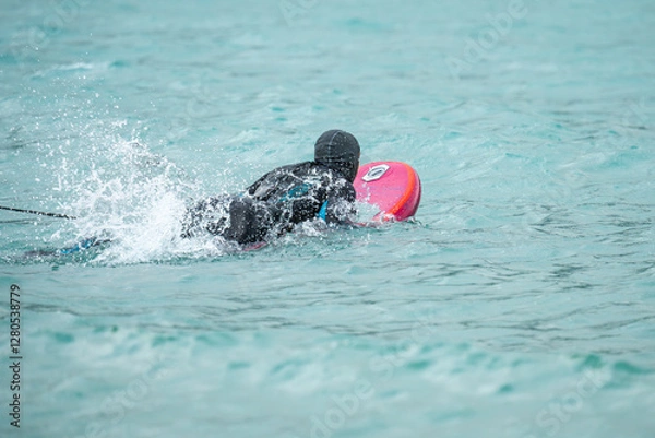 Fototapeta Wingfoil is a sport combining kitesurfing and windsurfing. Moment of getting into the water. Wing foil is a dynamically developing sport for everyone