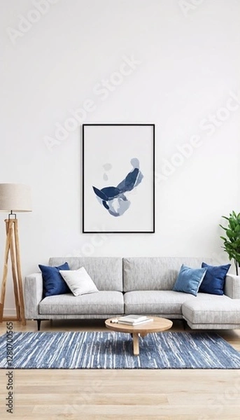 Obraz A living room with a couch and coffee table sitting on top of a blue rug.