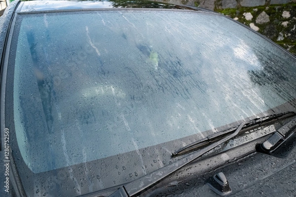 Fototapeta A car window covered in mist, with condensation forming a foggy pattern, set in an outdoor environment