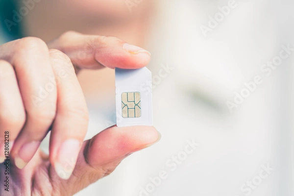 Obraz Hand holding sim card, select focus, color effect