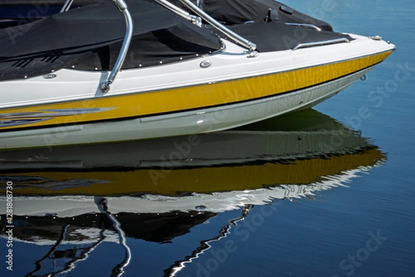Fototapeta Close up of the front bow of a speedboat and its reflection on water