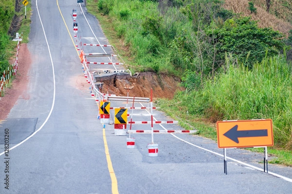 Obraz Damaged road with caution traffic sign