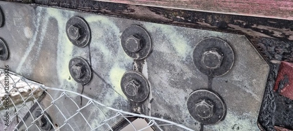 Fototapeta Metal bolts on foot bridge in winter with cold rime closeup
