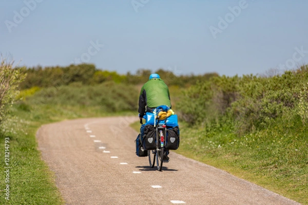 Fototapeta Cyclist on a bike path in the dunes Noordwijk