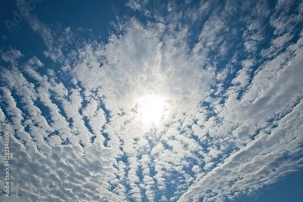 Fototapeta A bright blue sky with scattered clouds, leaving ample space for text about new beginnings