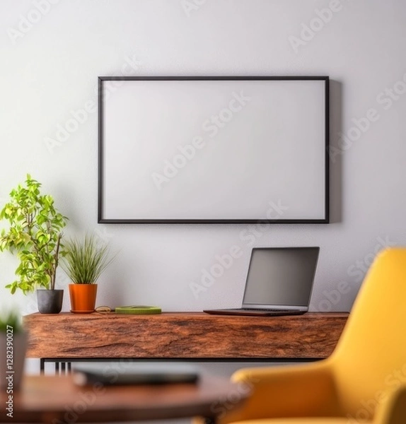 Fototapeta Modern Workspace with Minimalist Decor, Laptop, Plants, and Blank Picture Frame on Wall in Bright Room