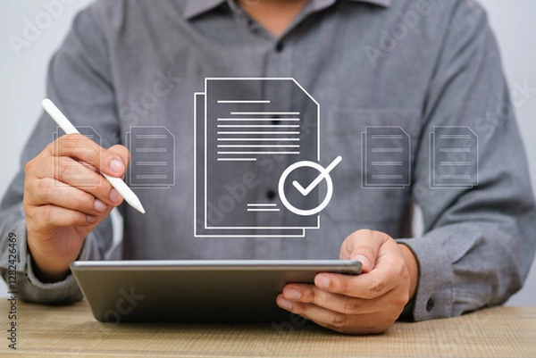 Fototapeta Close-up of a person using a tablet and stylus, with digital documents and checkmark overlay, representing digital approval and modern business solutions.