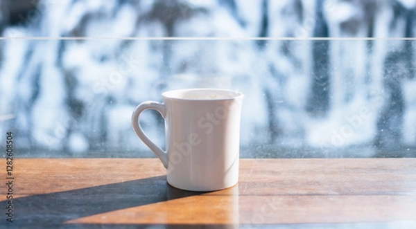 Fototapeta White coffee mug with snow background in winter
