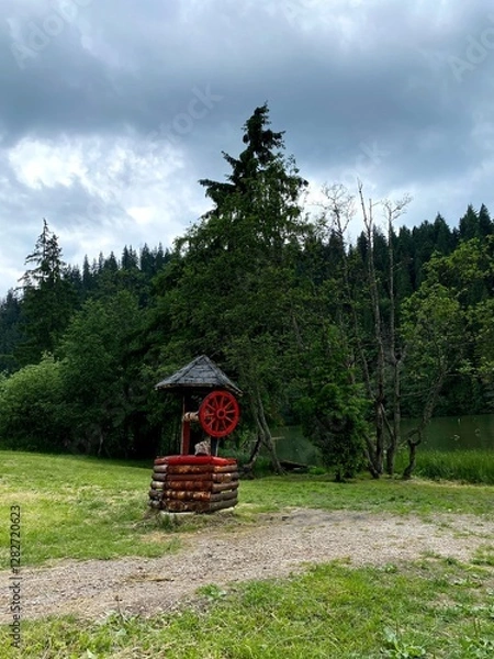Fototapeta Red water well in the forest