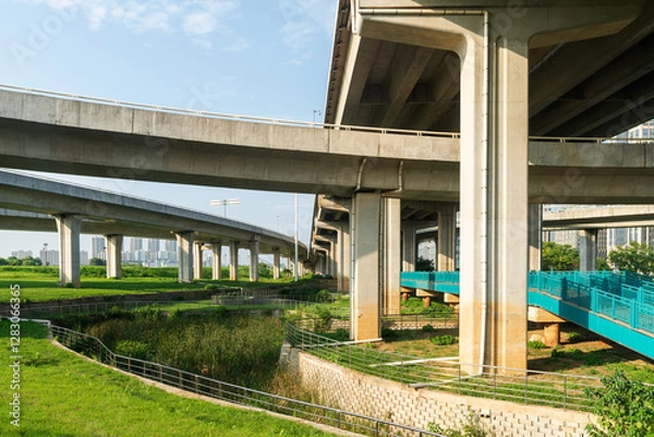 Fototapeta Concrete structure and asphalt road space under the overpass in the city