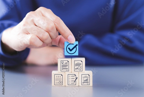 Obraz Document review process and quality control concept. Hand placing checkmark. wooden blocks document icons, certified, document verification, business approval process, certificate management, audit,